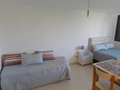 a bedroom with a bed and a couch and a table at CiTriPio dpto con Aire acondiconado , wifi y TV in Cordoba