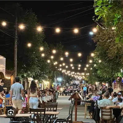 a crowd of people walking around a street at night at Sendero de Luna in Santa Rosa de Calamuchita