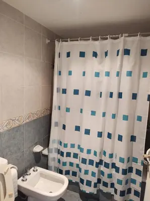 a bathroom with a shower curtain and a sink at Piso entero en la mejor ubicación in Cordoba