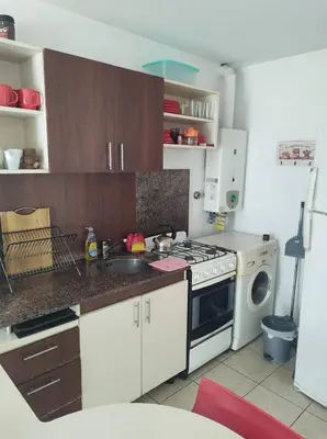 a kitchen with a stove and a washing machine at Piso entero en la mejor ubicación in Cordoba