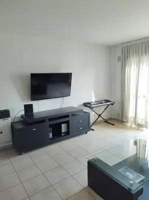 a living room with a flat screen tv on a wall at Piso entero en la mejor ubicación in Cordoba
