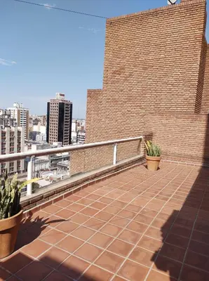 a balcony with a brick wall and some plants at Piso entero en la mejor ubicación in Cordoba