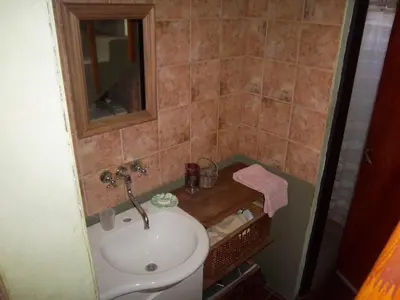 a bathroom with a sink and a mirror at Cabaña Arroyo de los Patos in Arroyo de Los Patos