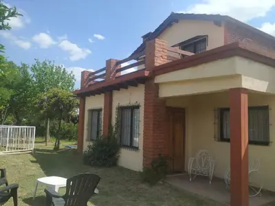 a small house with two chairs and a table at Cabaña Arroyo de los Patos in Arroyo de Los Patos