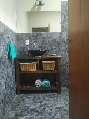 a bathroom with a sink and a mirror at Cabaña Arroyo de los Patos in Arroyo de Los Patos