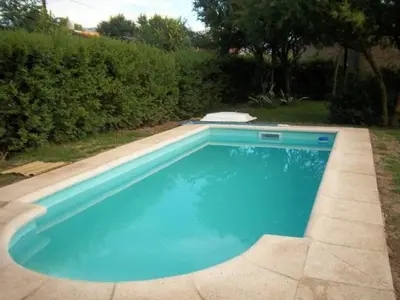 a large blue swimming pool in a yard at Cabaña Arroyo de los Patos in Arroyo de Los Patos