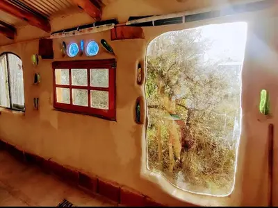a window on a train with a view of a field at ECO-LOFT, Sombra de Chañar,- Mallín Córdoba in Tanti