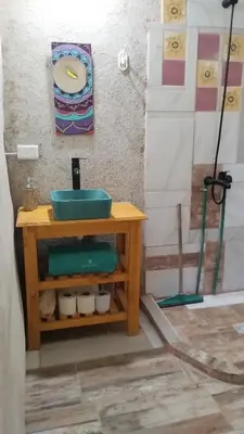 a bathroom with a sink and a shower at ECO-LOFT, Sombra de Chañar,- Mallín Córdoba in Tanti