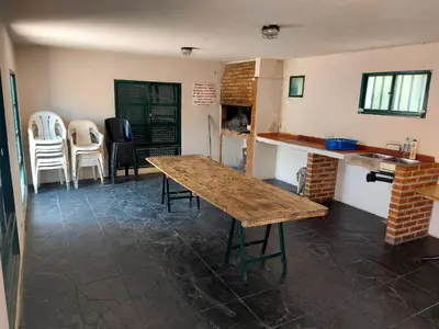a room with a wooden table and chairs in it at Castillo Del Lago - Carlos Paz - D07 in Villa Carlos Paz