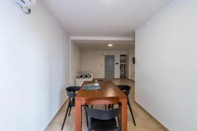 a dining room with a wooden table and chairs at Departamento familiar en Nueva Cordoba by lofty in Cordoba