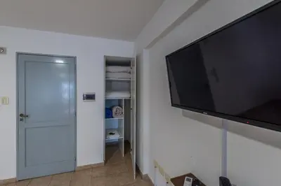 a large flat screen tv hanging on a wall at Departamento familiar en Nueva Cordoba by lofty in Cordoba