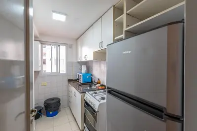 a kitchen with white cabinets and a refrigerator at Departamento familiar en Nueva Cordoba by lofty in Cordoba