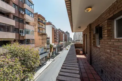 an empty street in a city with buildings at Departamento familiar en Nueva Cordoba by lofty in Cordoba