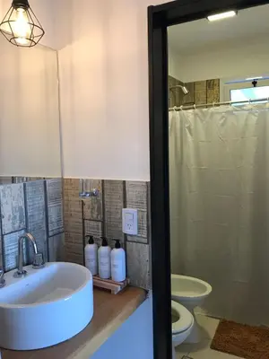 a bathroom with a sink and a toilet at La Pasionaria casa de sierras in Santa Rosa de Calamuchita