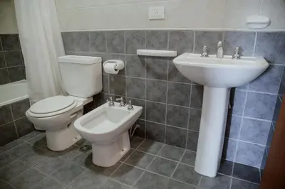 a bathroom with a toilet and a sink at Departamento en Obispo Trejo by Lofty in Cordoba