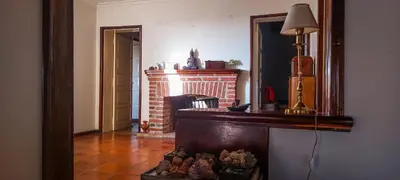 a living room with a fireplace and a mirror at El Solar de los Pájaros in Merlo