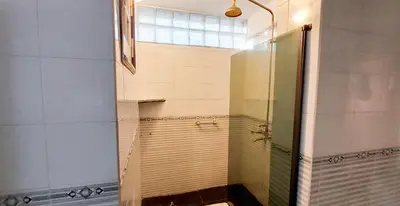 a shower with a glass door in a bathroom at El Solar de los Pájaros in Merlo