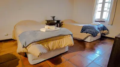 a room with two beds in a room at El Solar de los Pájaros in Merlo