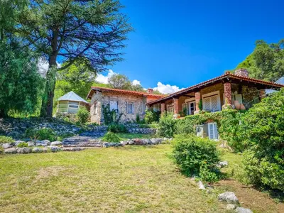 a house with a yard in front of it at El Solar de los Pájaros in Merlo