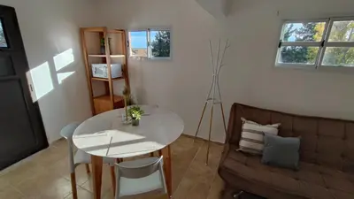 a living room with a white table and a couch at Winds Hill Resort & Spa in Merlo