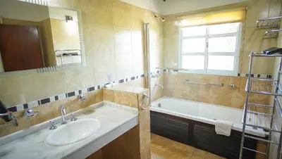 a bathroom with a sink and a bath tub at Winds Hill Resort & Spa in Merlo
