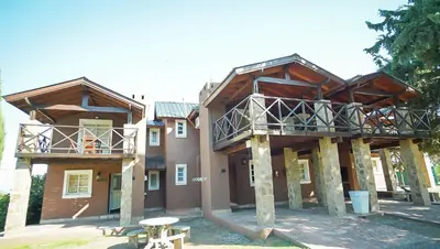 a large building with a balcony on top of it at Winds Hill Resort & Spa in Merlo