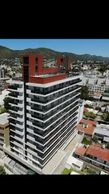a large white building in a city with buildings at Edificio Leonardo departamento 16 in Villa Carlos Paz