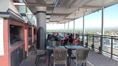 a restaurant with tables and chairs on a balcony at Edificio Leonardo departamento 16 in Villa Carlos Paz