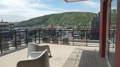 a balcony with two chairs and a view of a city at Edificio Leonardo departamento 16 in Villa Carlos Paz