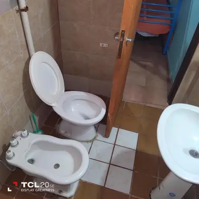 a bathroom with a toilet and a sink at Pecas house in Mina Clavero