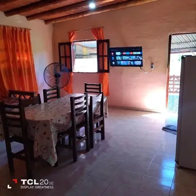 a dining room with a table and chairs at Pecas house in Mina Clavero