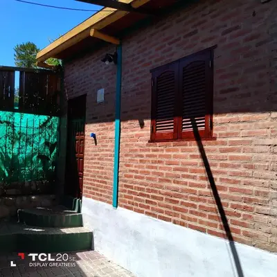 a brick building with a window on the side of it at Pecas house in Mina Clavero