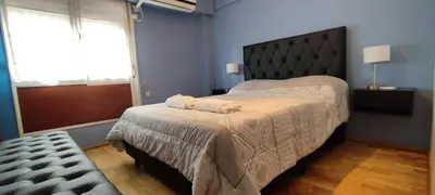 a bedroom with a bed with two towels on it at Nueva Córdoba departamento de una habitacion con vista al Parque in Cordoba