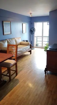 a living room with a bed and a table at Nueva Córdoba departamento de una habitacion con vista al Parque in Cordoba