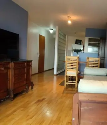 a living room with a bed and a table and chairs at Nueva Córdoba departamento de una habitacion con vista al Parque in Cordoba