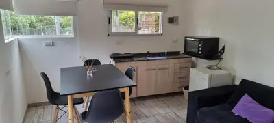 a small living room with a table and a tv at Departamento Costa Paz in Villa Carlos Paz