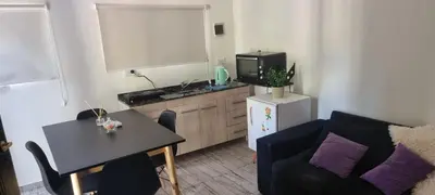 a living room with a couch and a table and a kitchen at Departamento Costa Paz in Villa Carlos Paz