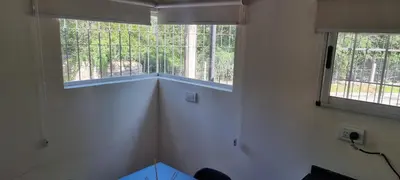 a small room with two windows in a house at Departamento Costa Paz in Villa Carlos Paz