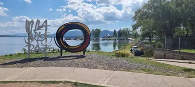 a large mirror in front of a body of water at Departamento Costa Paz in Villa Carlos Paz