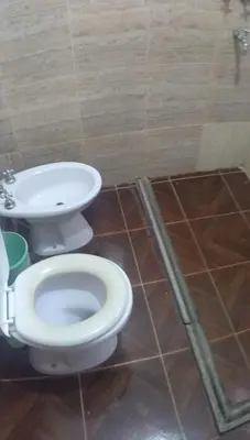 a bathroom with a toilet and a sink at Pecas house in Mina Clavero
