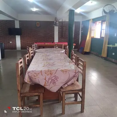 a table and chairs with a table at Pecas house in Mina Clavero