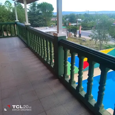 a balcony with a view of a playground at Pecas house in Mina Clavero