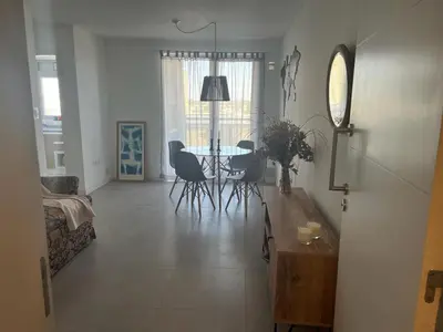 a living room with a table and chairs at CIUDAD GAMA A ESTRENAR 9 E in Cordoba