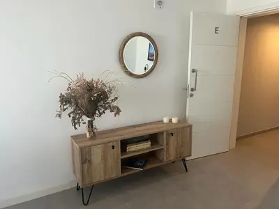 a room with a wooden cabinet with a mirror and a door at CIUDAD GAMA A ESTRENAR 9 E in Cordoba