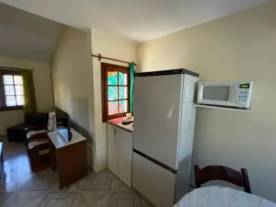a kitchen with a white refrigerator and a microwave at Casa céntrica en calle CB 297 in Villa Carlos Paz