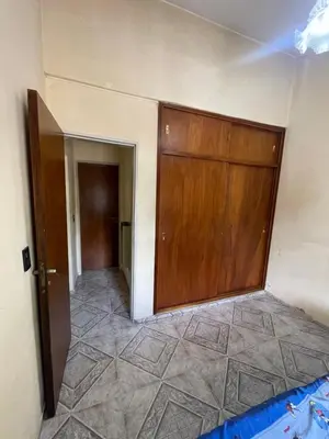 a room with a large wooden door and a hallway at Casa céntrica en calle CB 297 in Villa Carlos Paz