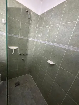 a bathroom with a shower with a glass door at Casa céntrica en calle CB 297 in Villa Carlos Paz
