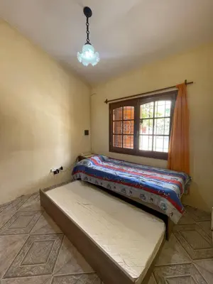 a bed in a room with a window at Casa céntrica en calle CB 297 in Villa Carlos Paz