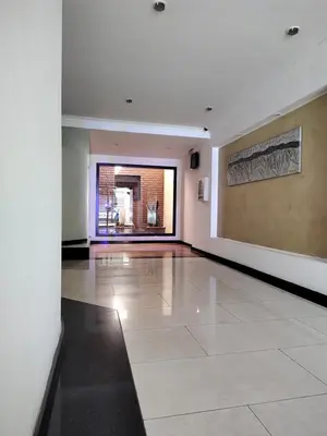 a large empty room with a large window and a tile floor at Dpto dos dormitorios en Nueva Córdoba in Cordoba