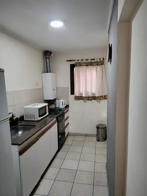 a small kitchen with a sink and a microwave at Dpto dos dormitorios en Nueva Córdoba in Cordoba
